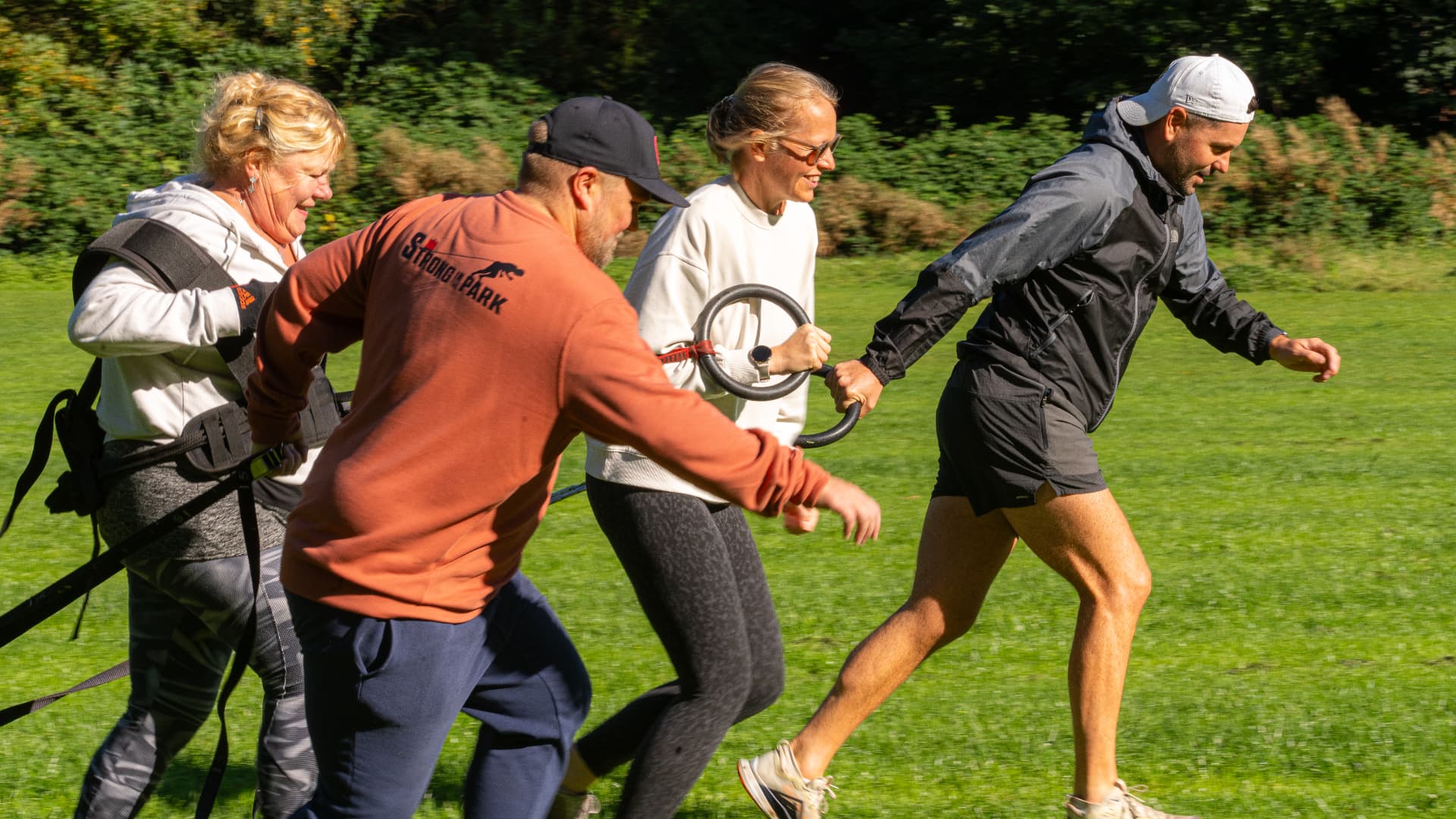 Members moving together during a team drill on the grass